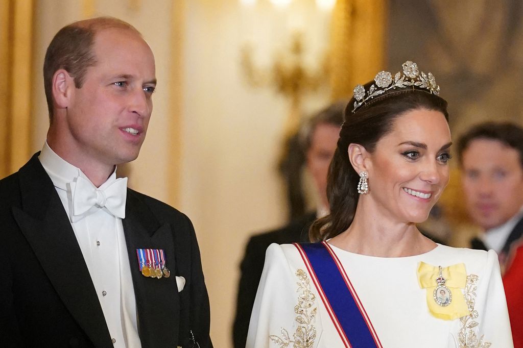 Close-up of William wearing a white tuxedo and Kate in a white gown and tiara 