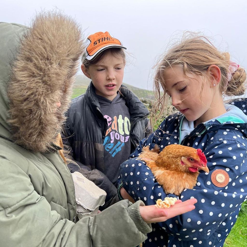 Amanda Owen's children and a chicken at their family farm