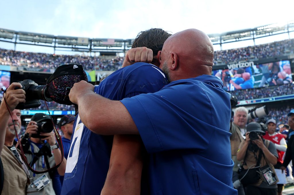 Jaxson Dart #6 of the New York Giants hugs head coach Brian Daboll of the New York Giants following a win against the Los Angeles Chargers after the game at MetLife Stadium on September 28, 2025 in East Rutherford, New Jersey