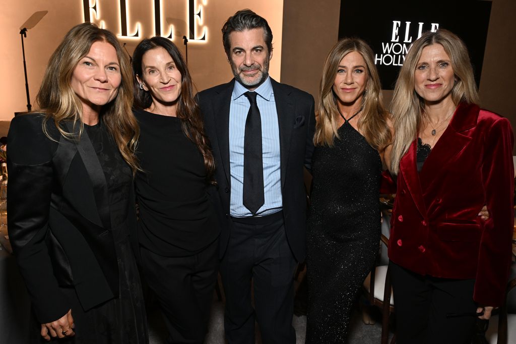Kristin Hahn, Amanda Anka, Jim Curtis, Jennifer Aniston, wearing Ralph Lauren, and Andrea Bendewald stand in a line