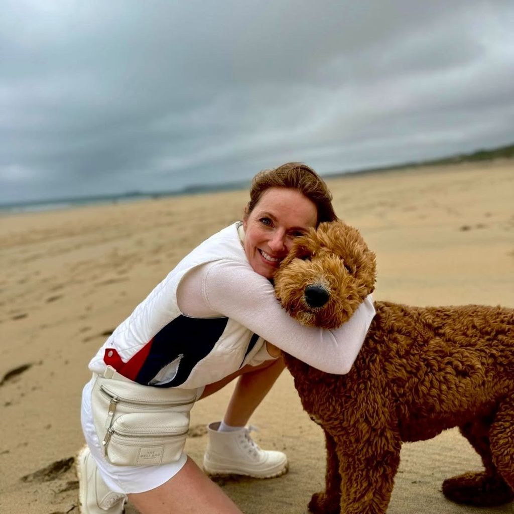 Geri Halliwell Horner hugging pet dog