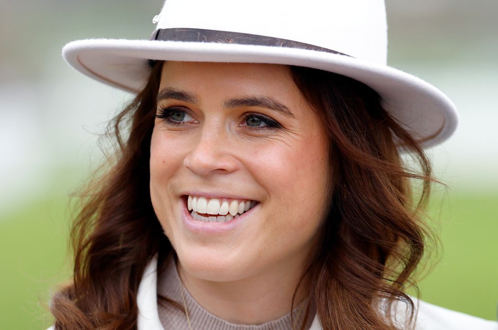 Princess Eugenie wearing a white hat at The Cheltenham Festival