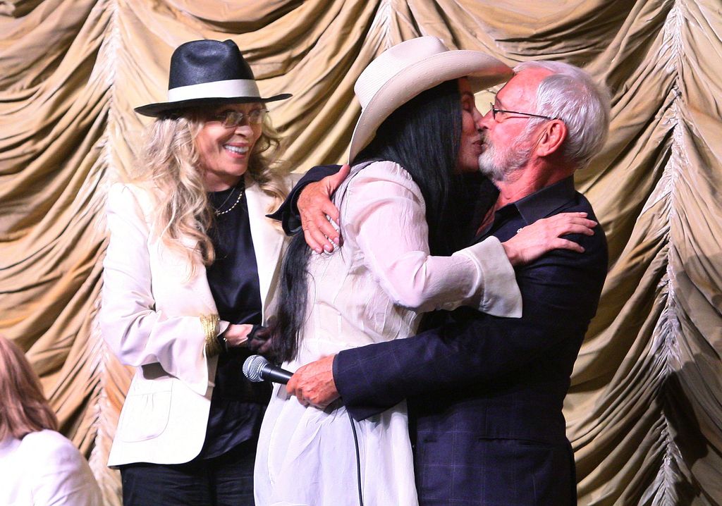 Cher (C) embraces director Norman Jewison as actress Faye Dunaway watches at a tribute to Jewison 
