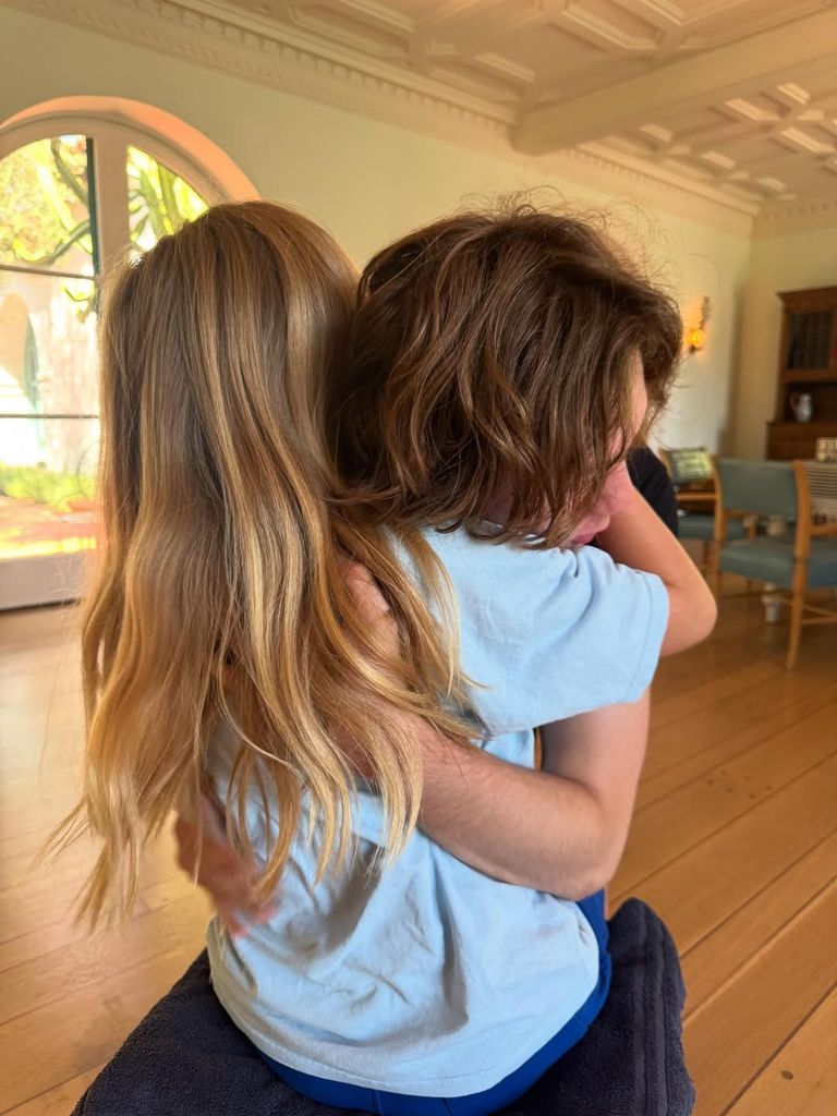 Sailor getting a hug ahead of his big hair transformation