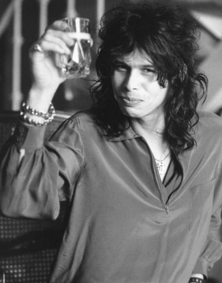 Steven Tyler toasting with a glass