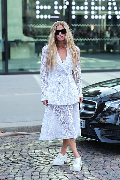 Woman wears white Chanel heeled loafers