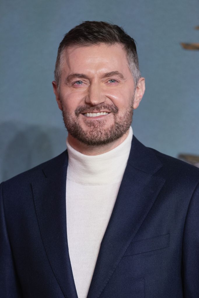 Richard Armitage smiling in a suit