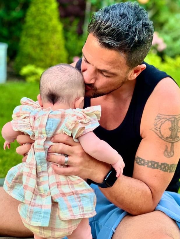 Peter Andre kissing a baby girl