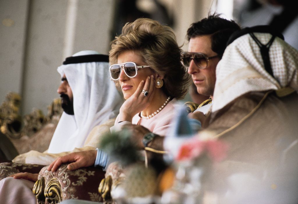 Prince Charles and Diana, Princess of Wales (1961 - 1997) attend a camel race at Al Maqam, near Al Ain in Abu Dhabi in the United Arab Emirates, March 1989. Diana is wearing a pale pink suit by Catherine Walker. 