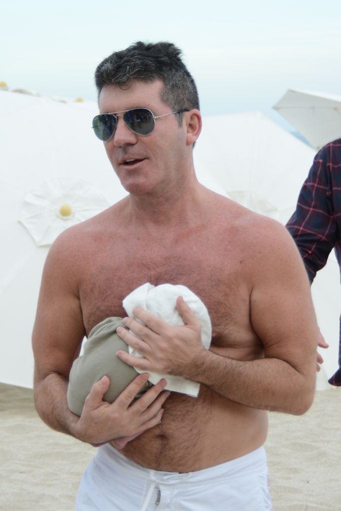 Simon Cowell cradles his newborn son in Miami in 2014