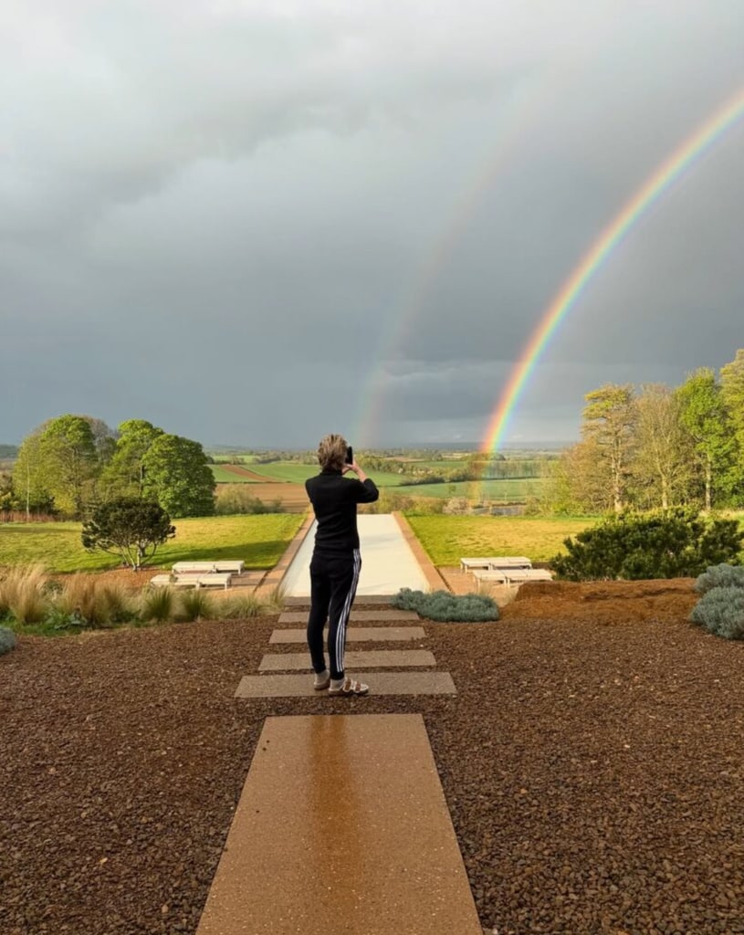Ellen Des Generes taking photo of a double rainbow 