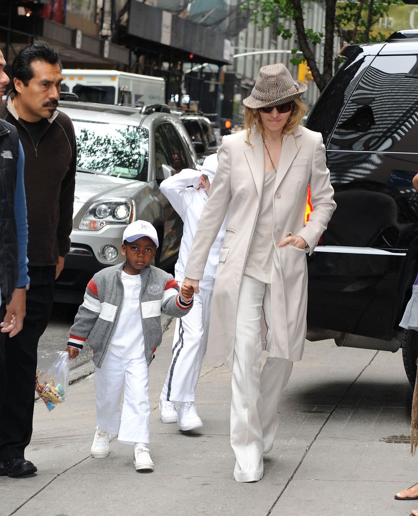 Madonna and David Banda in neutral outfits