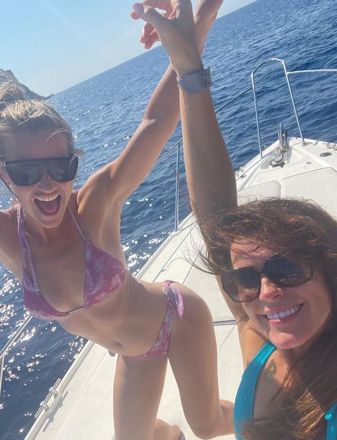 Helen Skelton and friend in bikinis partying on a boat