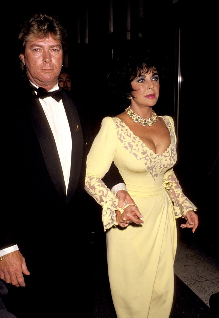 Larry Fortensky and Elizabeth Taylor holding hands