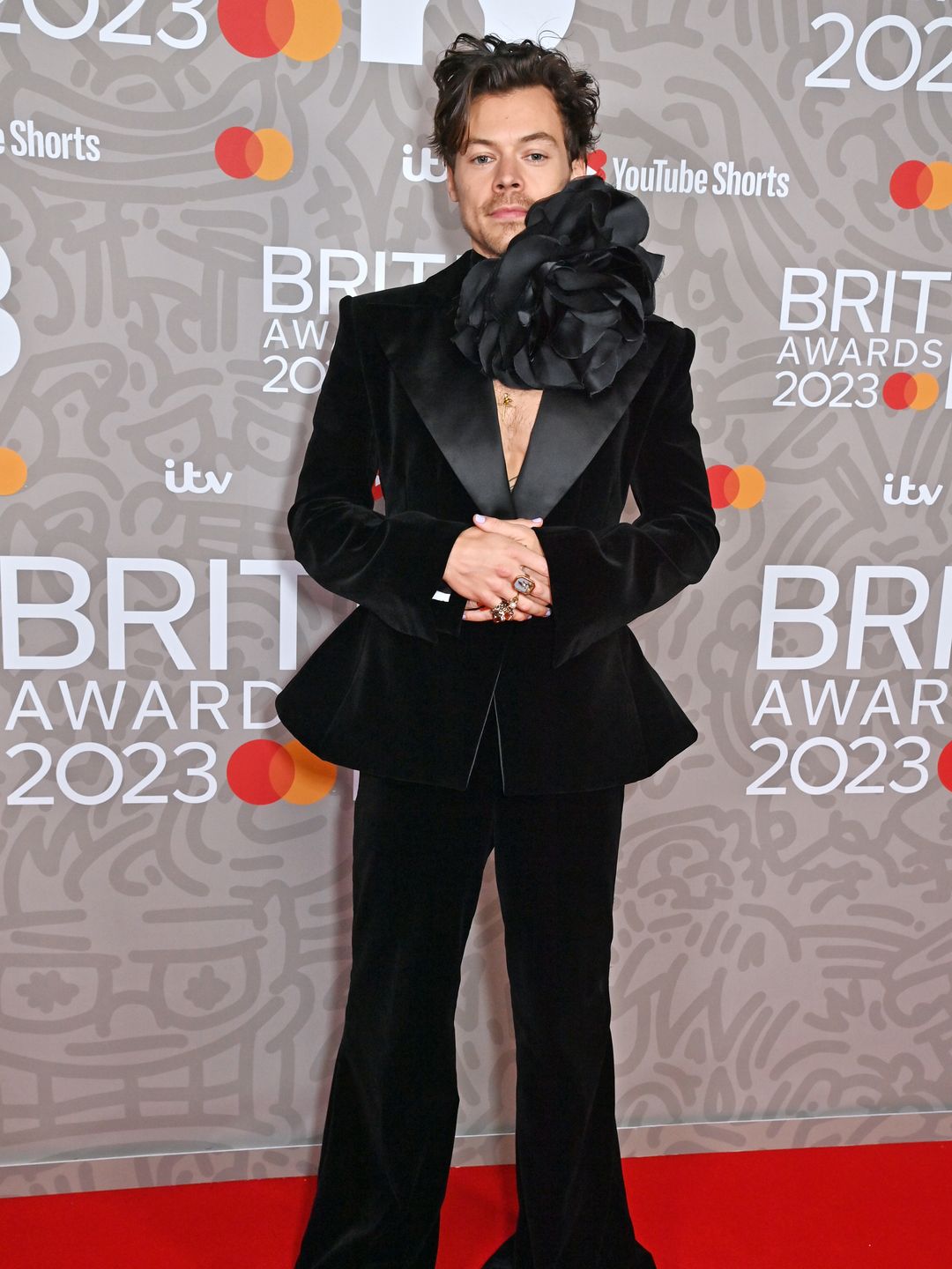 Harry Styles arrives at The BRIT Awards 2023 wearing a black suit