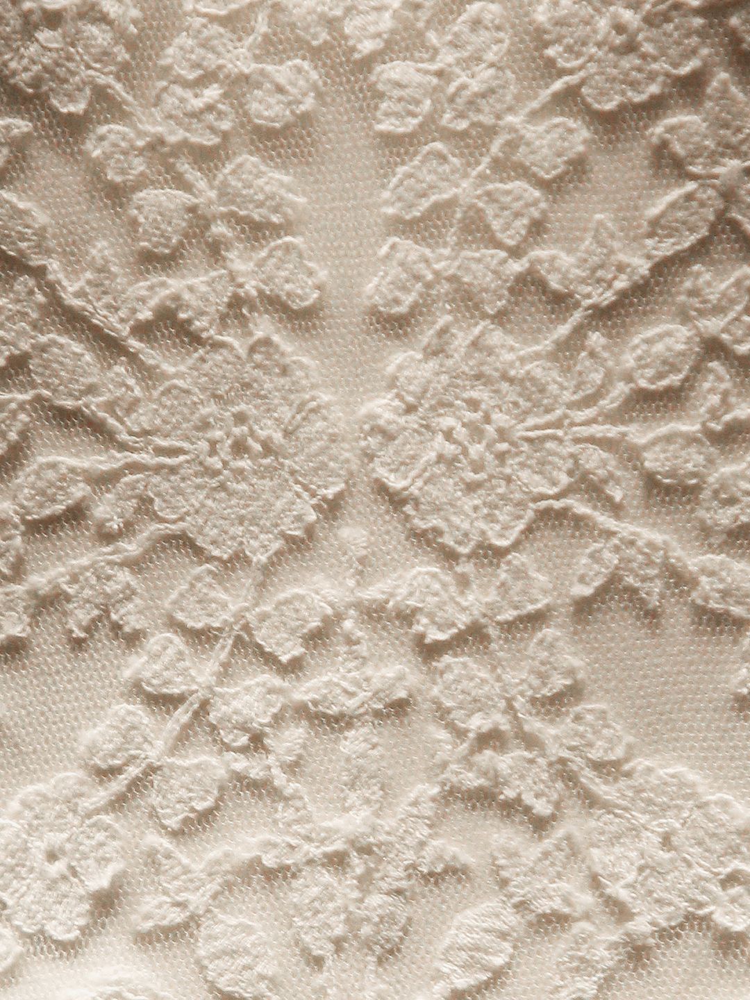 A close-up of the floral detailing in the dress