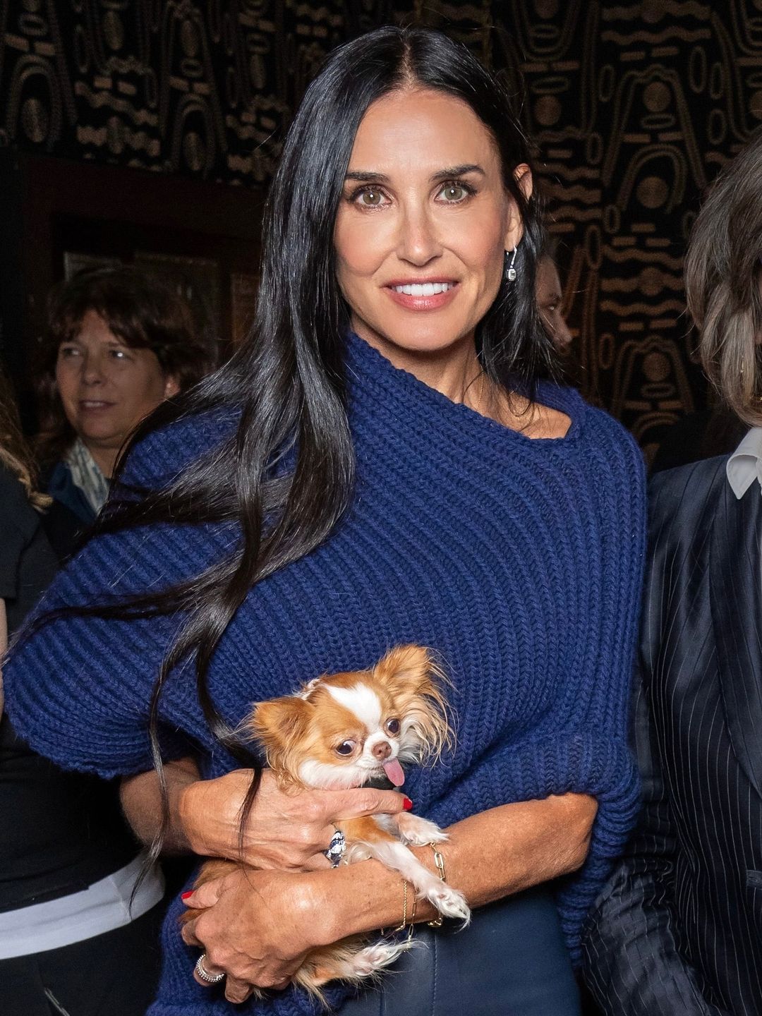 Demi Moore poses in a blue knit with her dog Pilaf