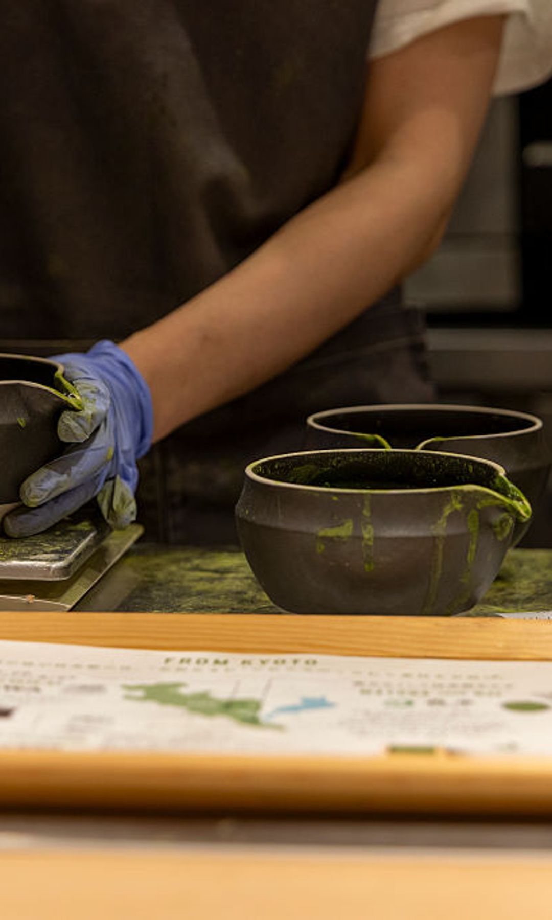 A young employee prepares ice cream and matcha drinks on July 24, 2025 in Kyoto, Japan.
