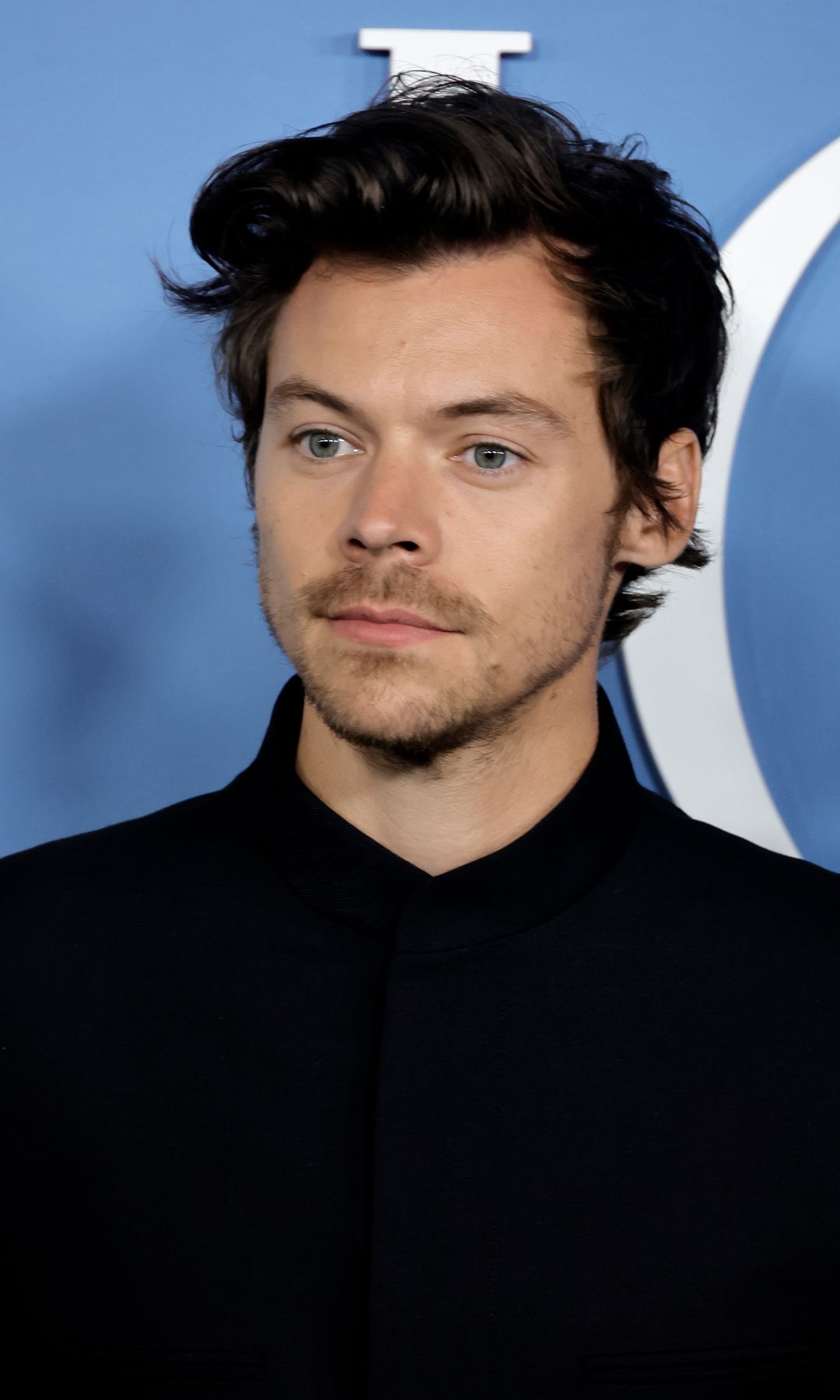 Harry Styles wearing a black suit