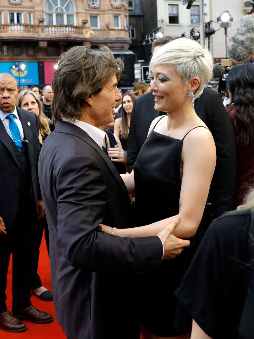 Pom Klementieff and Tom Cruise stop for a sweet reunion on the red carpet