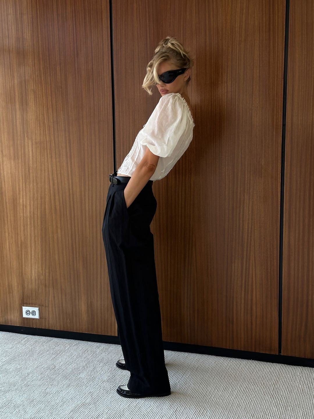 Elsa Hosk styles a pair of trousers with a white top on her Instagram