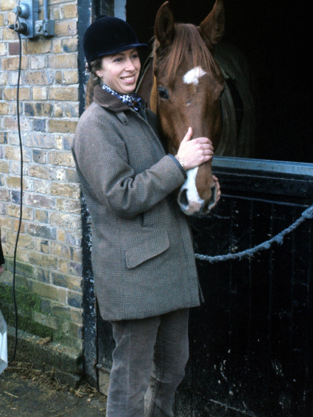 Princess Anne hugging a horse