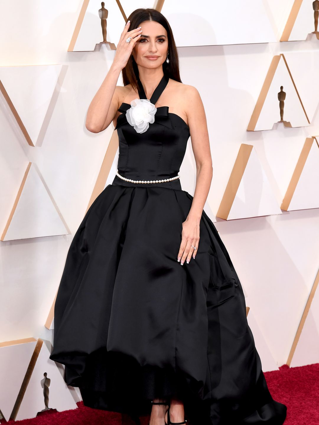 Penélope Cruz wears a black gown with a pearl belt to the 92nd Annual Academy Awards