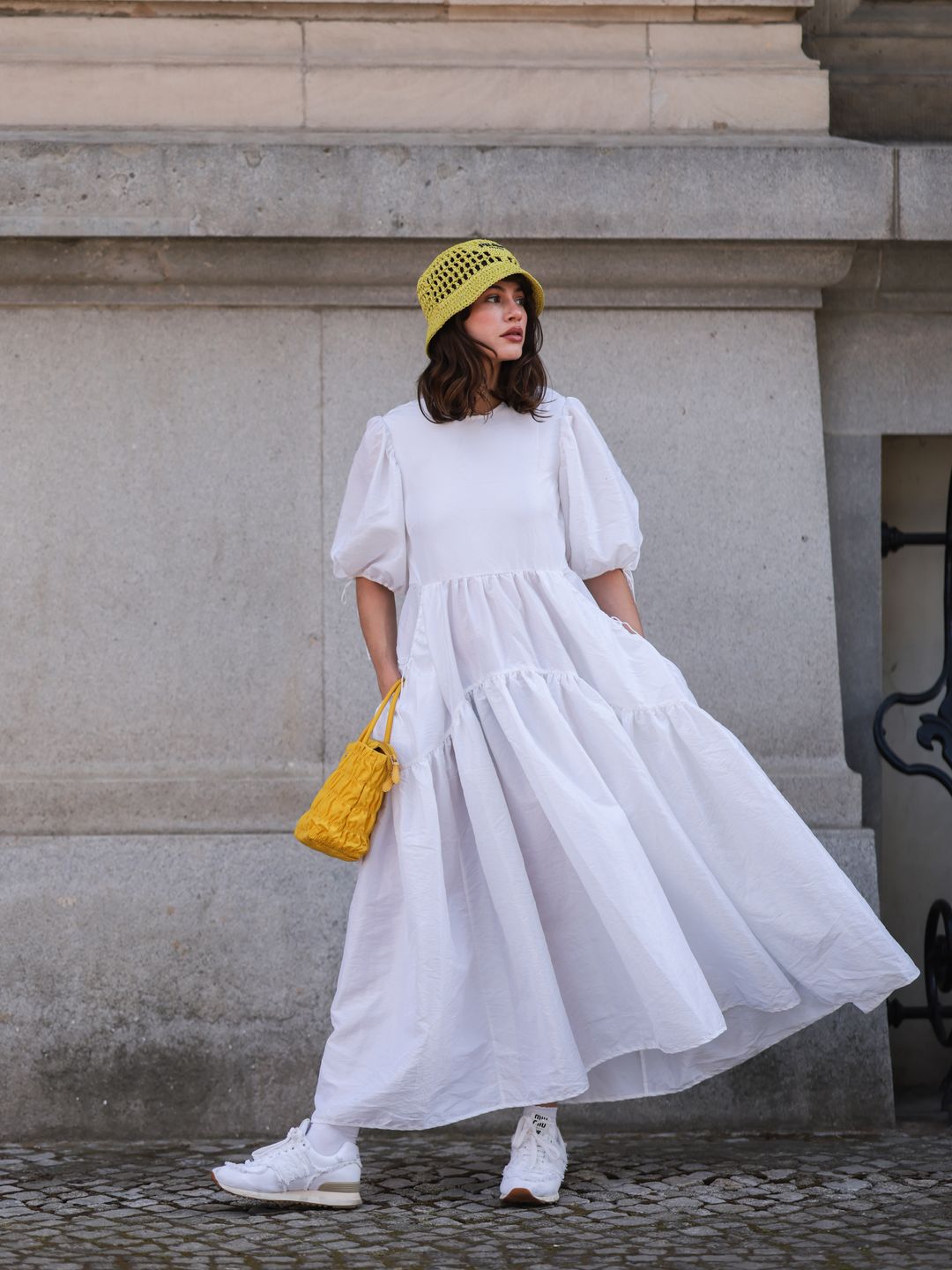 Lena Naumann styles a white tiered dress with sneakers from New Balance x Miu Miu's limited-edition collection 