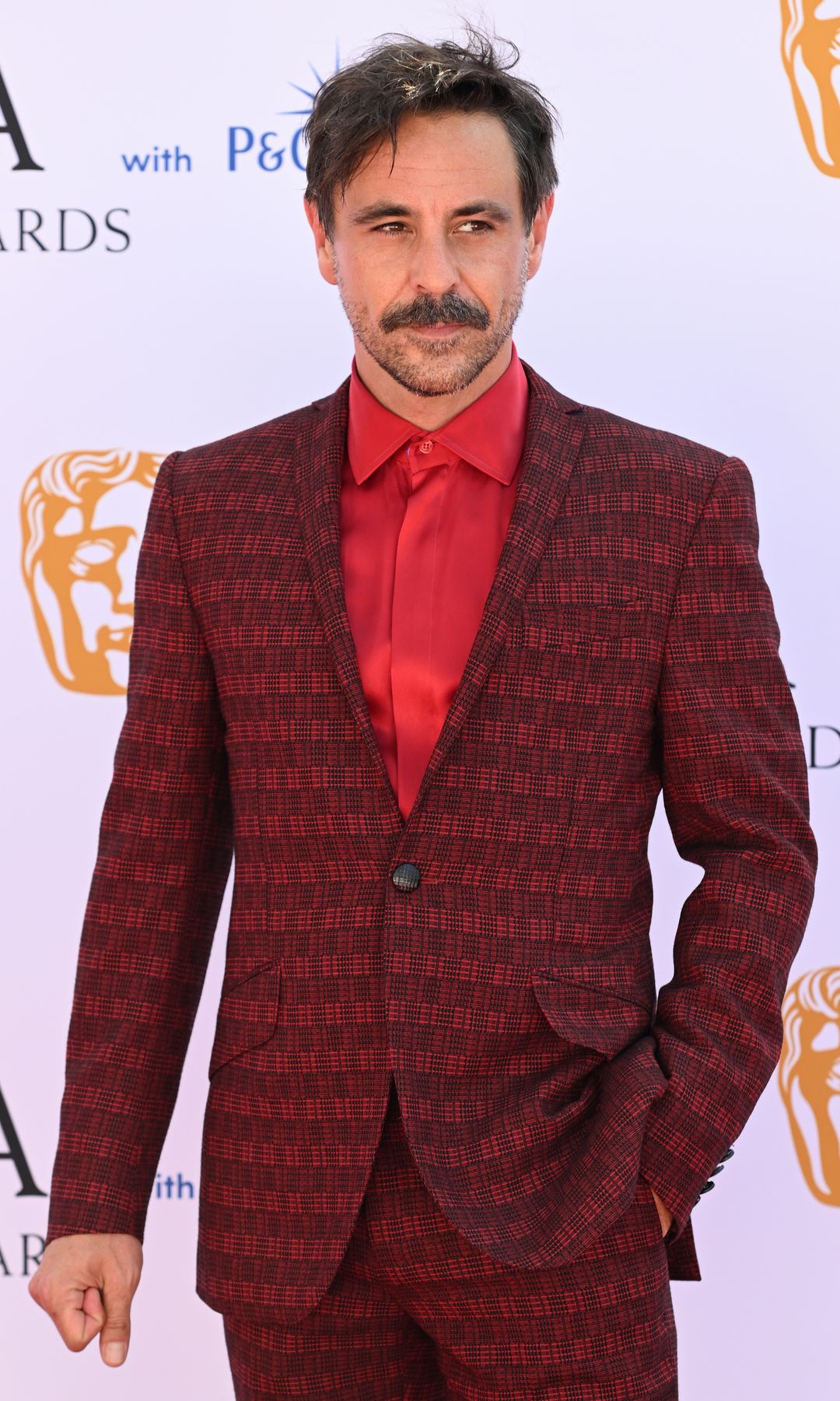 Emun Elliott in a red checkered suit