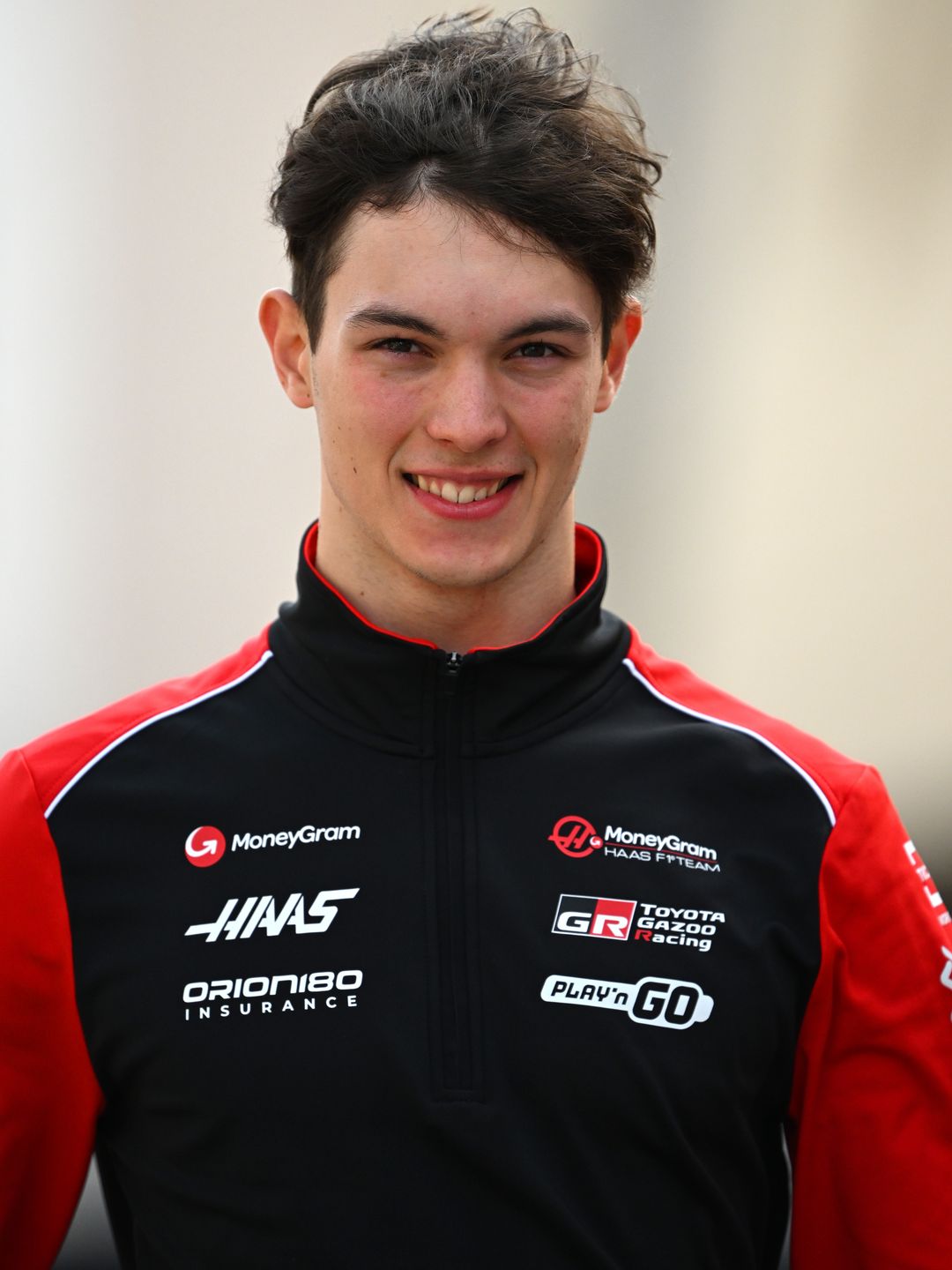 Oliver Bearman in a black and red team jacket