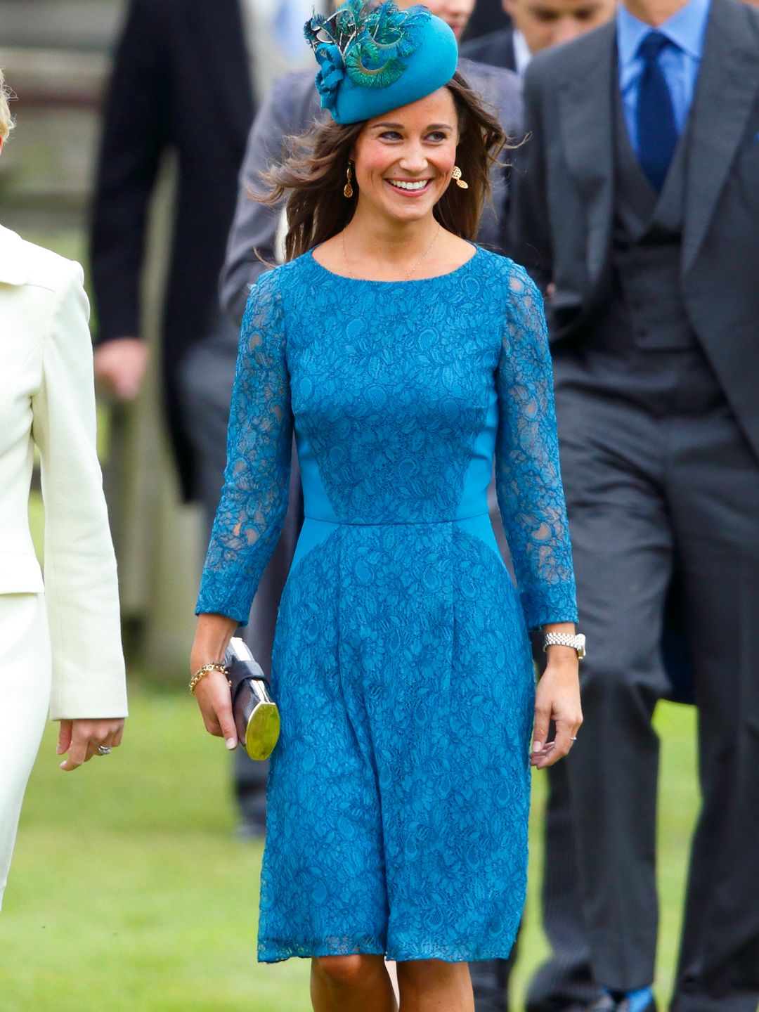 Pippa Middleton smiling in a blue lace dress