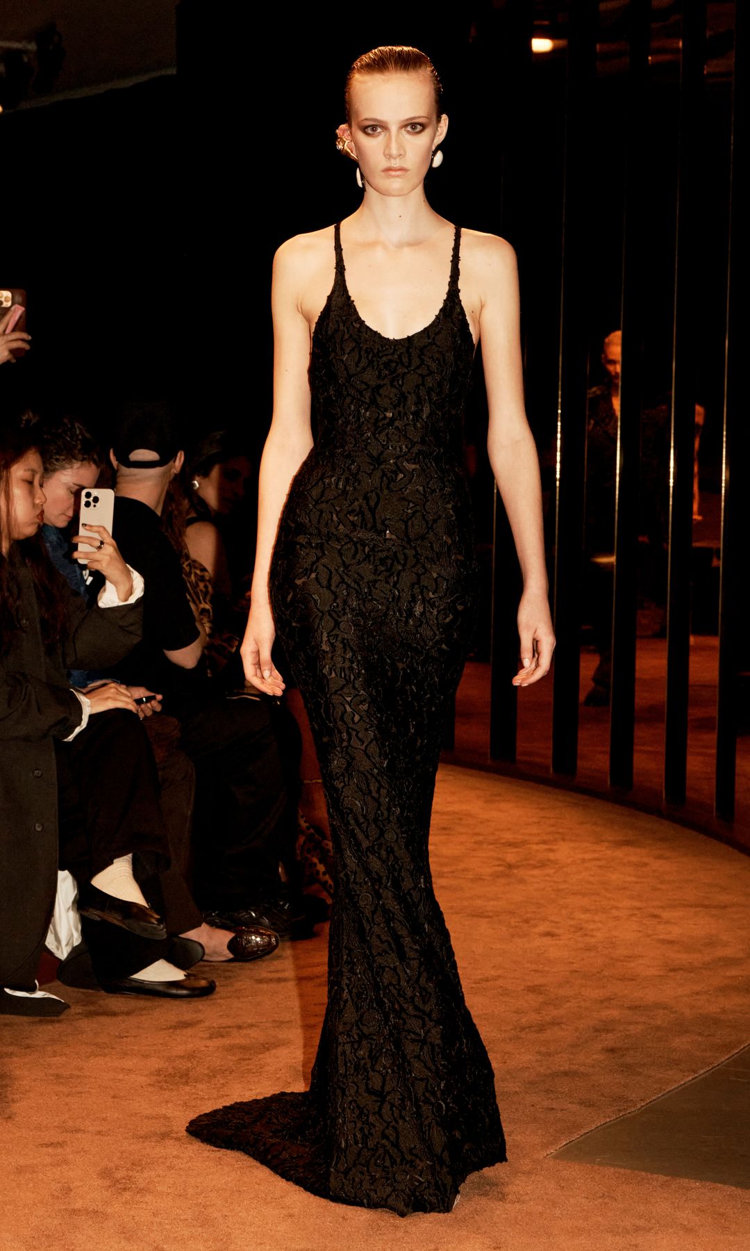 A model wears a black gown -look 34 from Schiaparelli's FW25 collection
