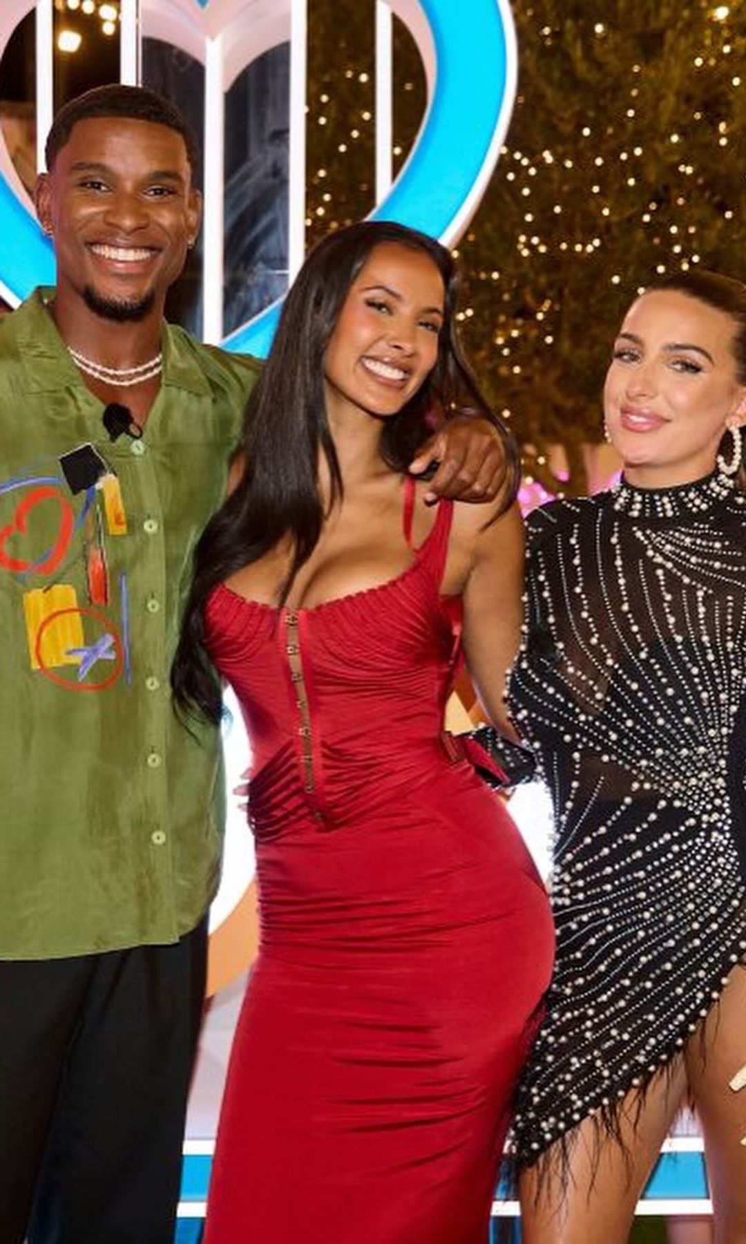 Maya Jama poses with Love Island 2025 winners Toni and Cach, Toni is wearing a black embellished sheer mini dress and Cach is wearing a green silk shirt with abstract design
