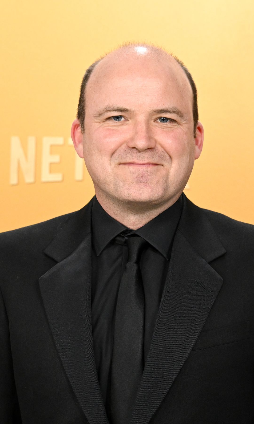 Rory Kinnear in a black suit