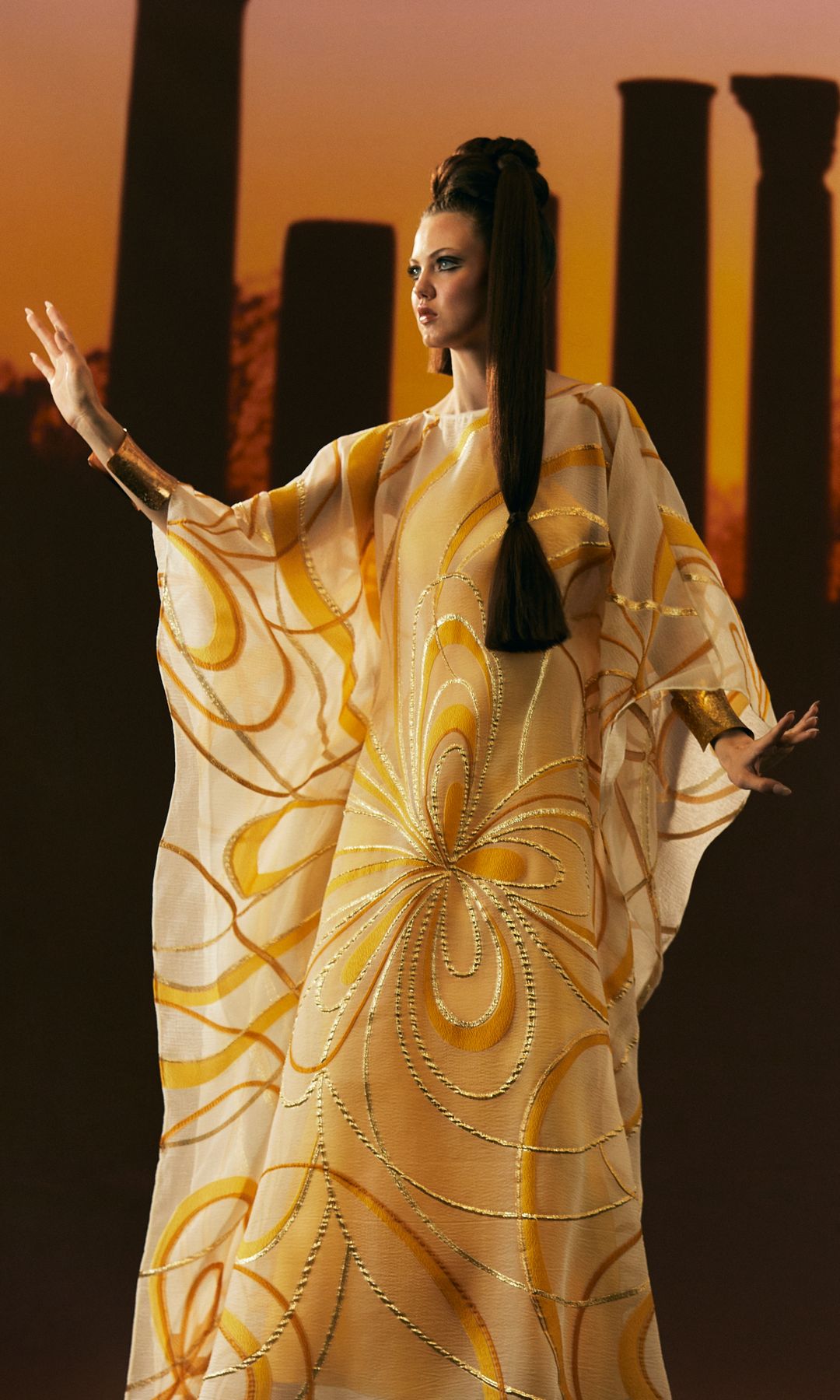 model in swiling gold kaftan