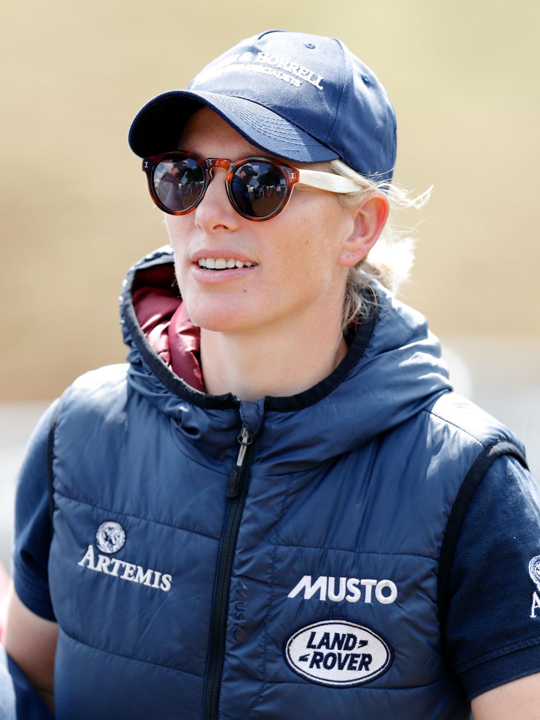 woman wearing blue gilet and cap