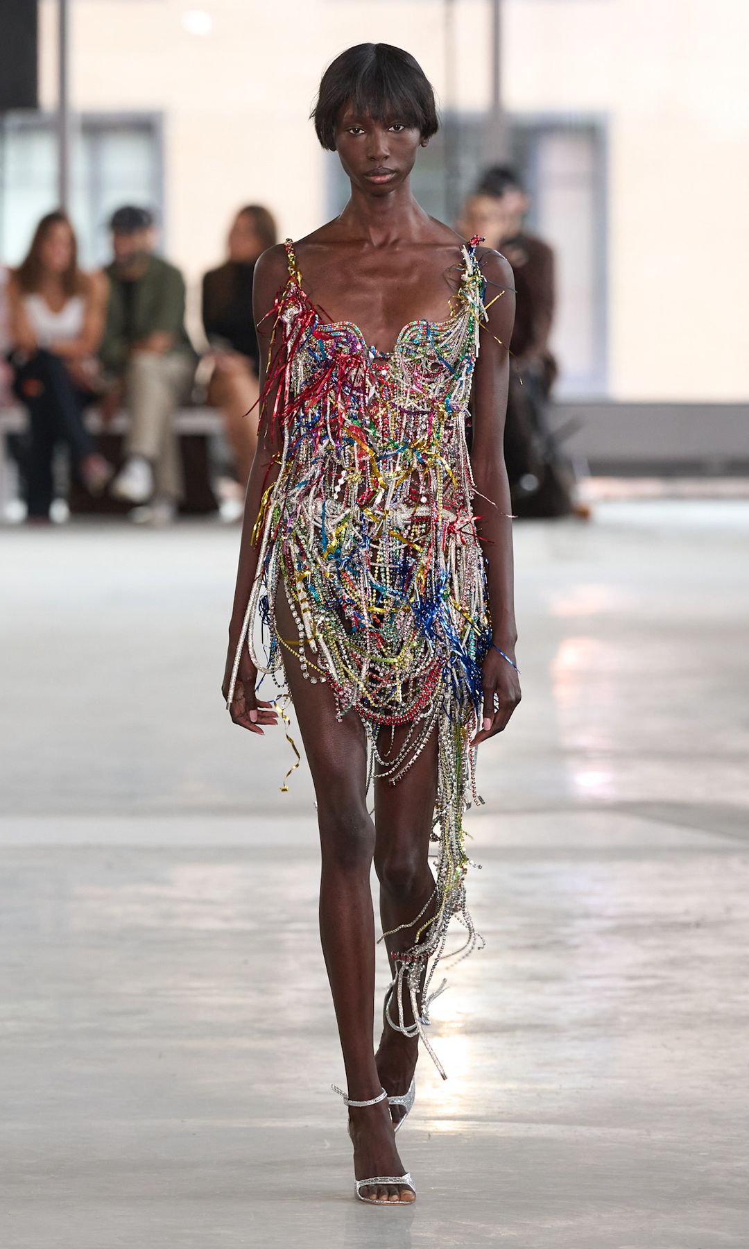 A chainmail mini dress in multi colours with lots of fringing on the runway at Area