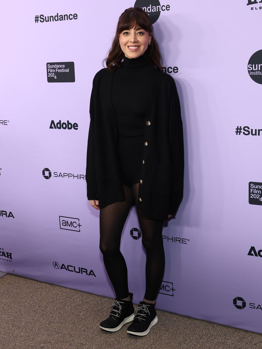 Aubrey Plaza wears a black turtleneck, cardigan, tights and mini shorts at 2024 Sundance Film Festival