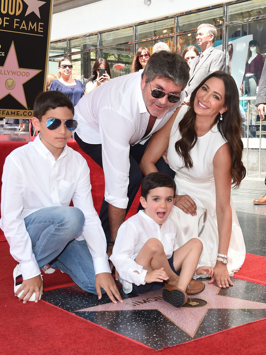 The family all together posing around Simon's Hollywood star