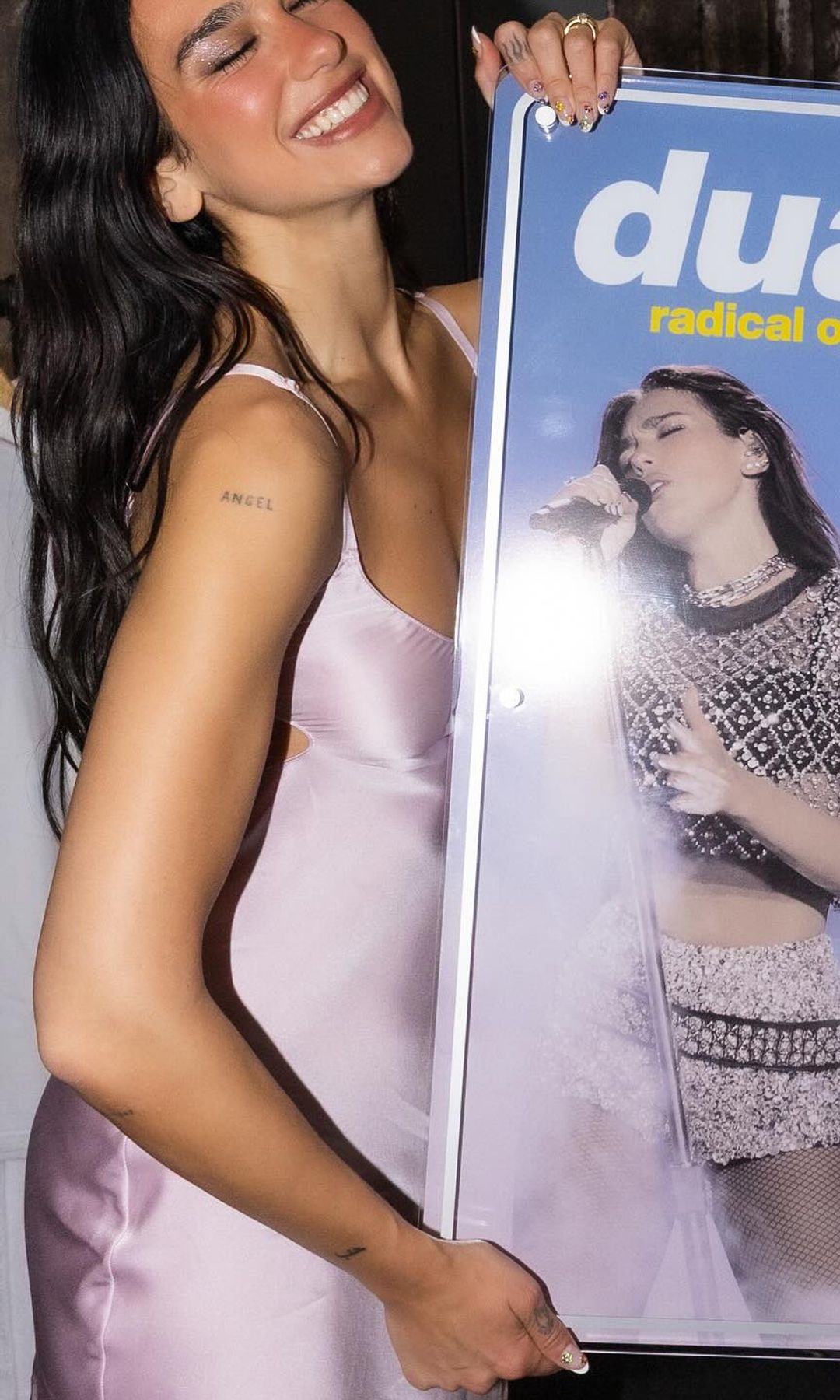 Dua Lipa poses in a pink dress