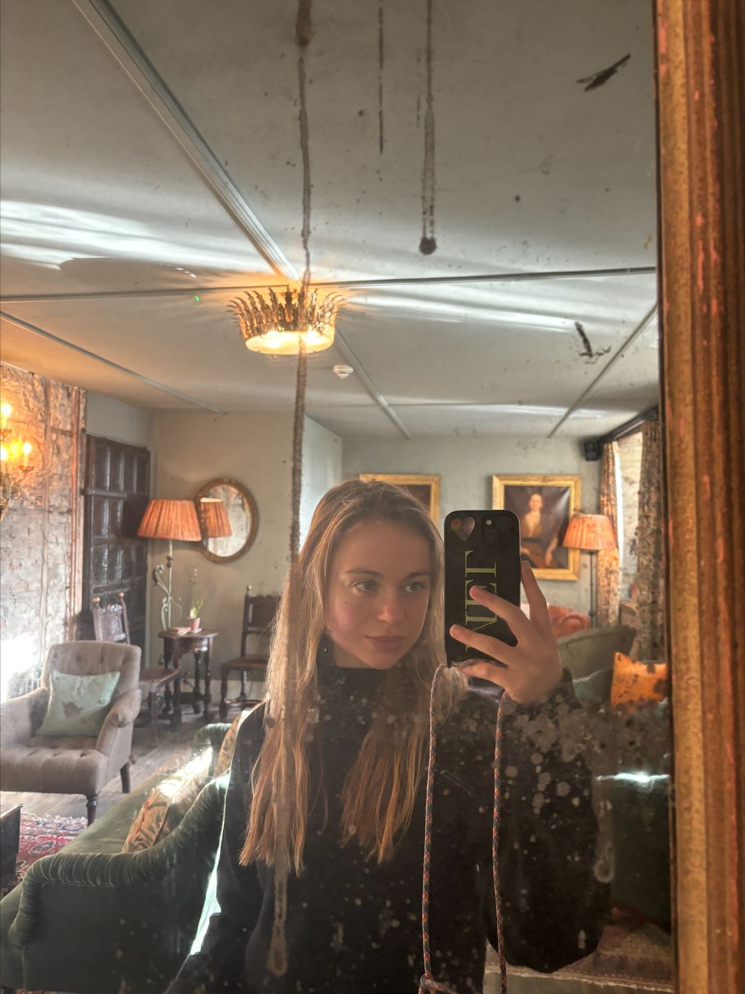 Amelia Windsor takes a mirror selfie in The Pig Hotel
