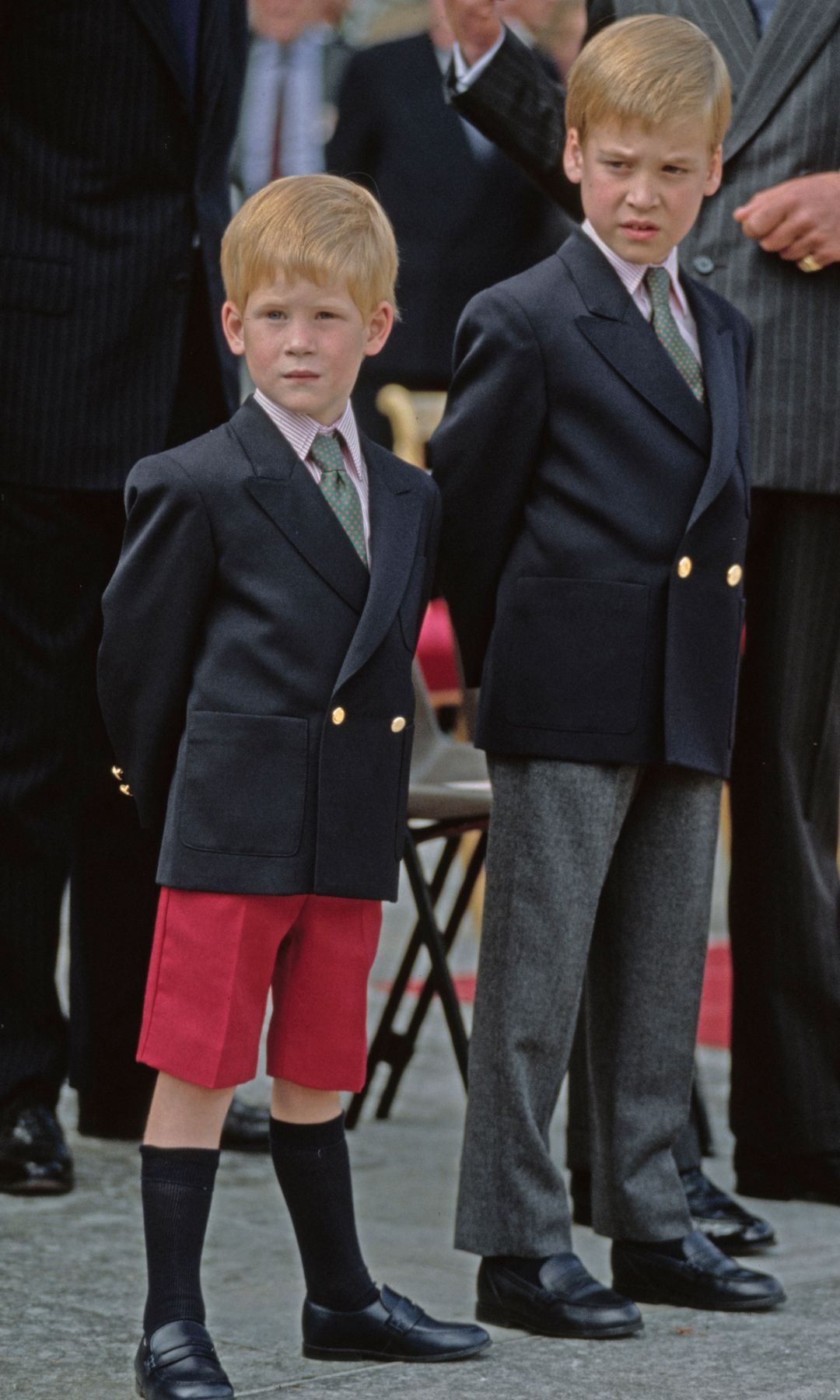 Prince Harry in red shorts with his arms behind his back