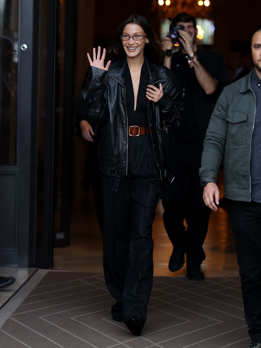 Bella Hadid is seen leaving her hotel on September 24, 2024 in Paris, France wearting a black leather jacket, trousers and glasses