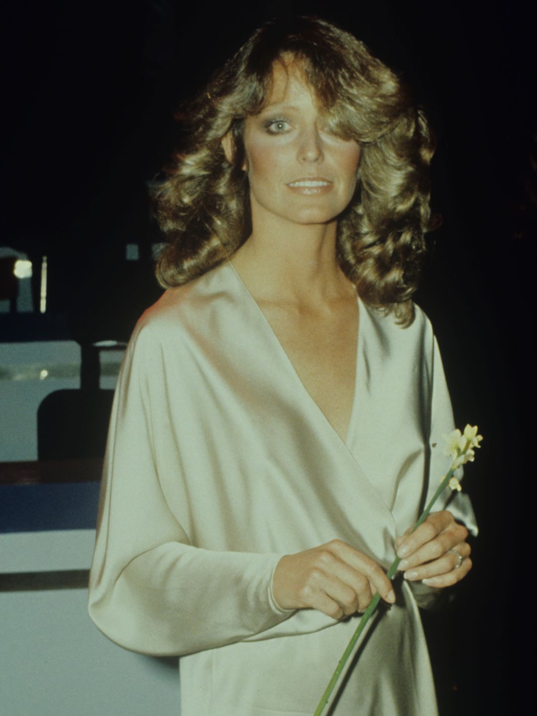 Farrah Fawcett (1947-2009), actress, pictured holding a flower at the London Palladium, London, Great Britain, circa 1985. (Photo by Keystone Colour/Getty Images)