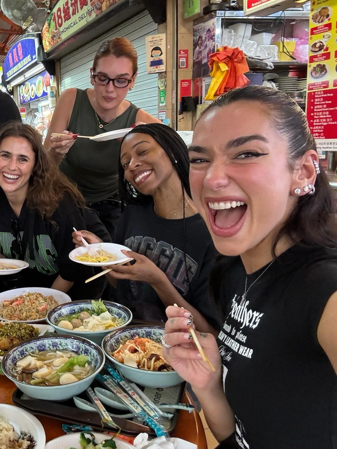 Dua Lipa poses with her tour team in Singapore