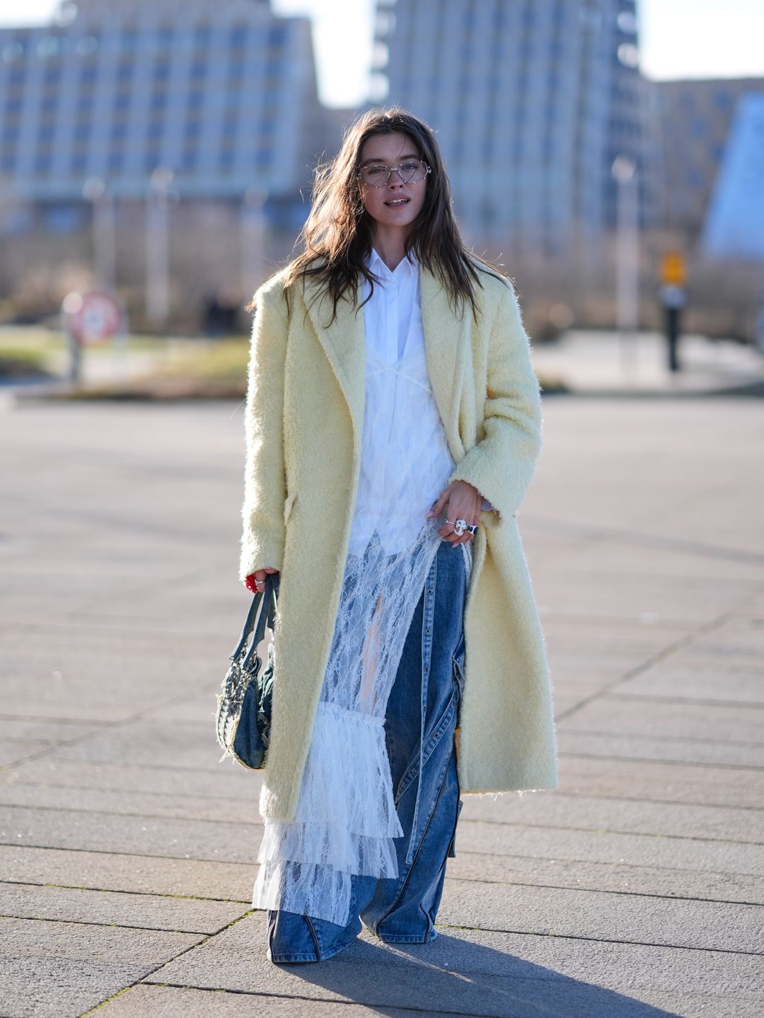 A Fashion Week guest wearing flares under a mesh dress 