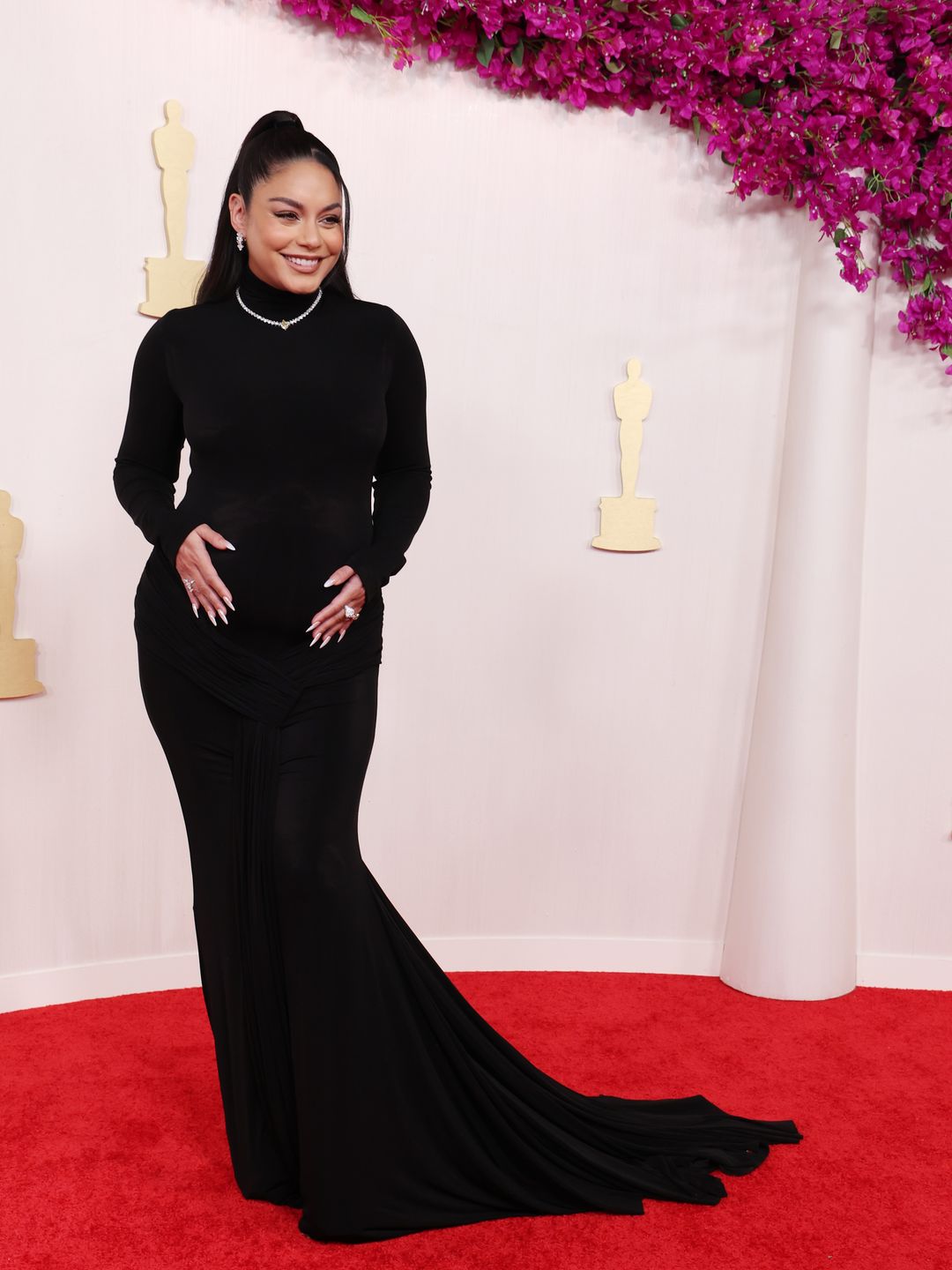 Vanessa Hudgens attends the 96th Annual Academy Awards in a black gown