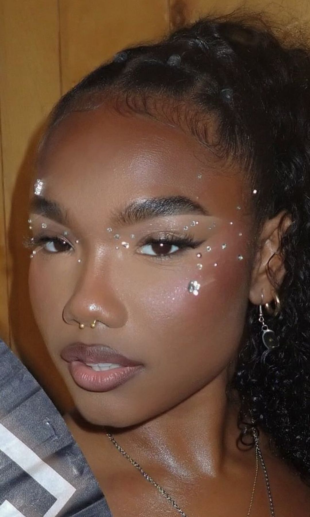 woman with silver glitter gems on her face 