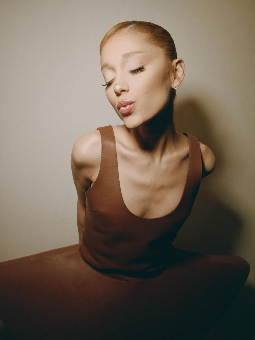 Ariana' Grande poses in a brown JW Anderson dress