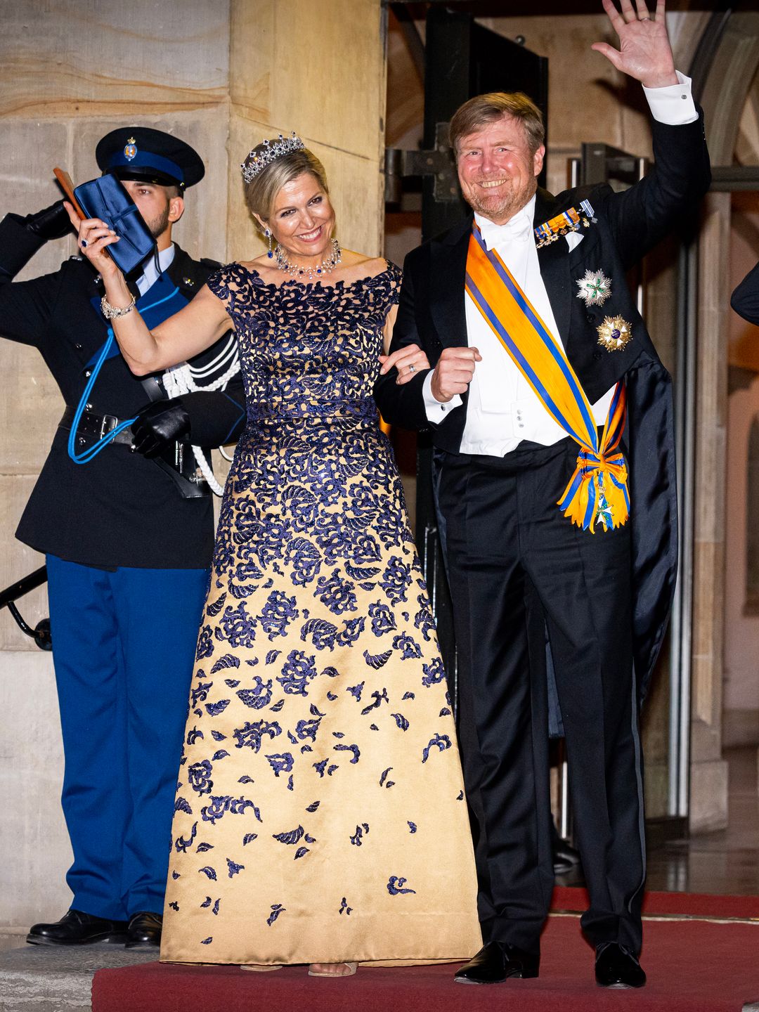 Queen Maxima of the Netherlands and King Willem-Alexander waving to crowds at the Diplomatic Corps gala dinner 